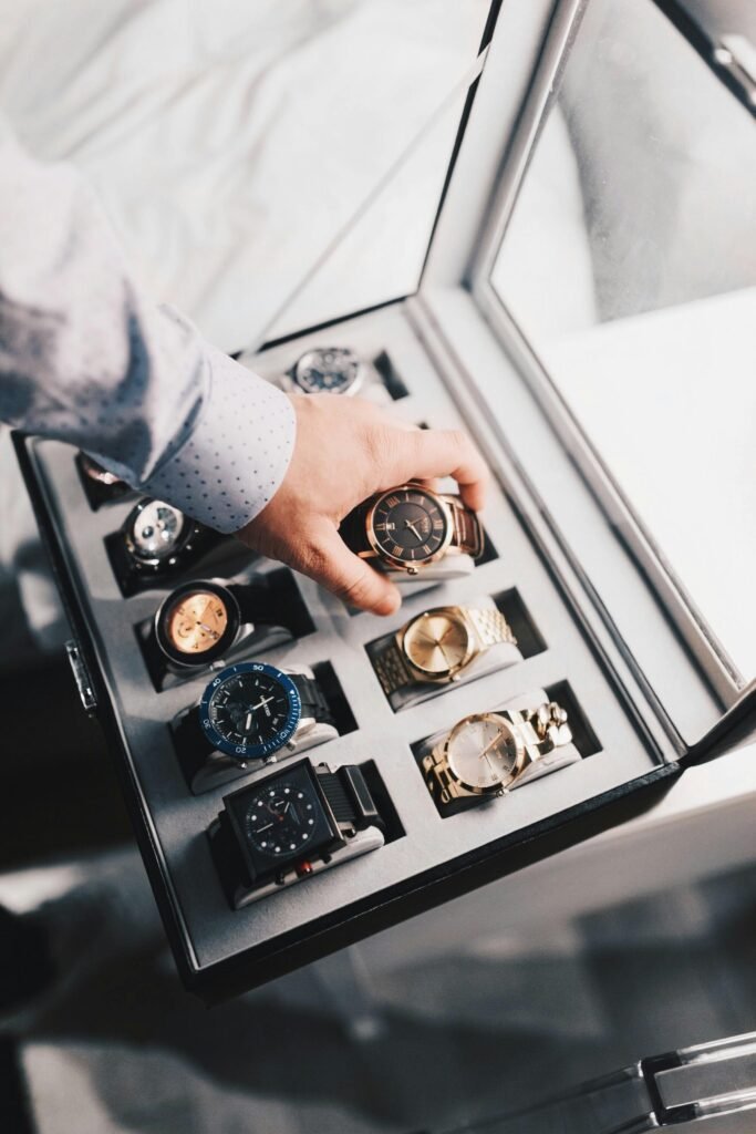 A box containing 8 different watches and a man selecting one of it