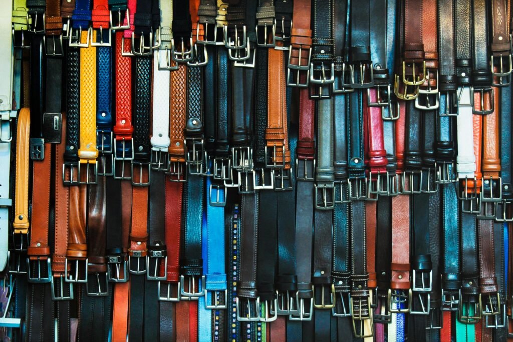 Lots of men's belt hanging in a shop