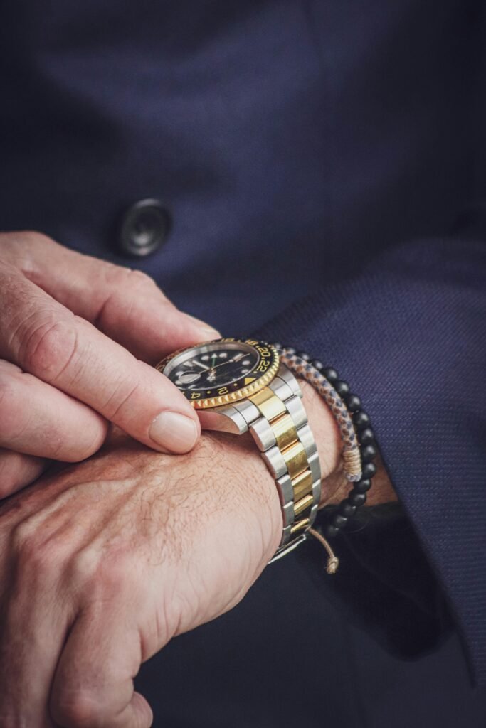 Man's wrist wearing a golden watch