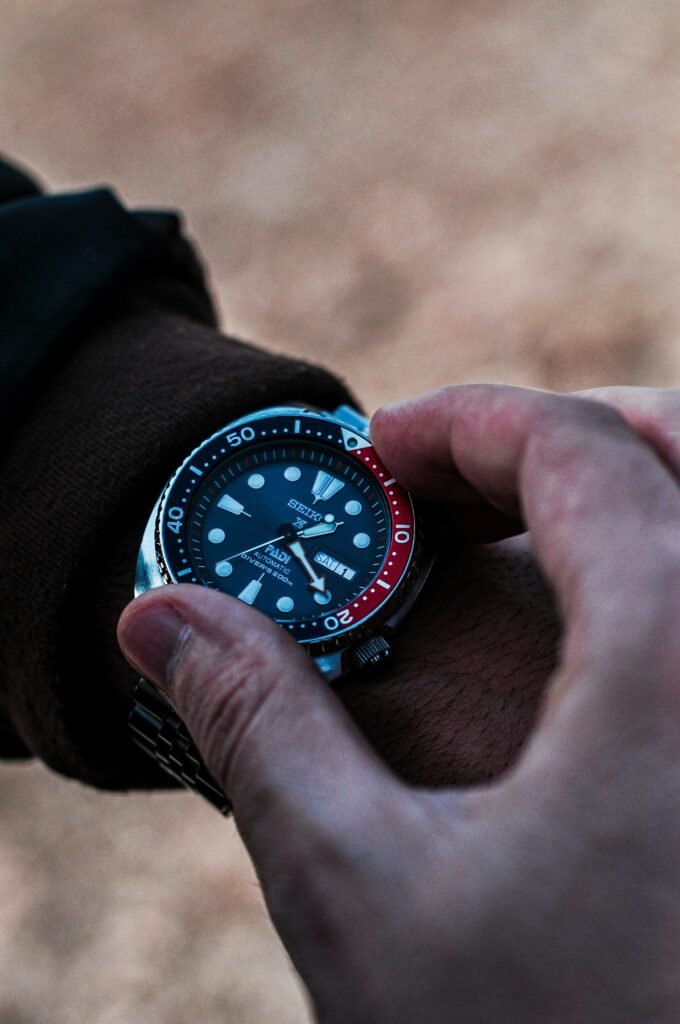A man's wrist wearing a diver watch
