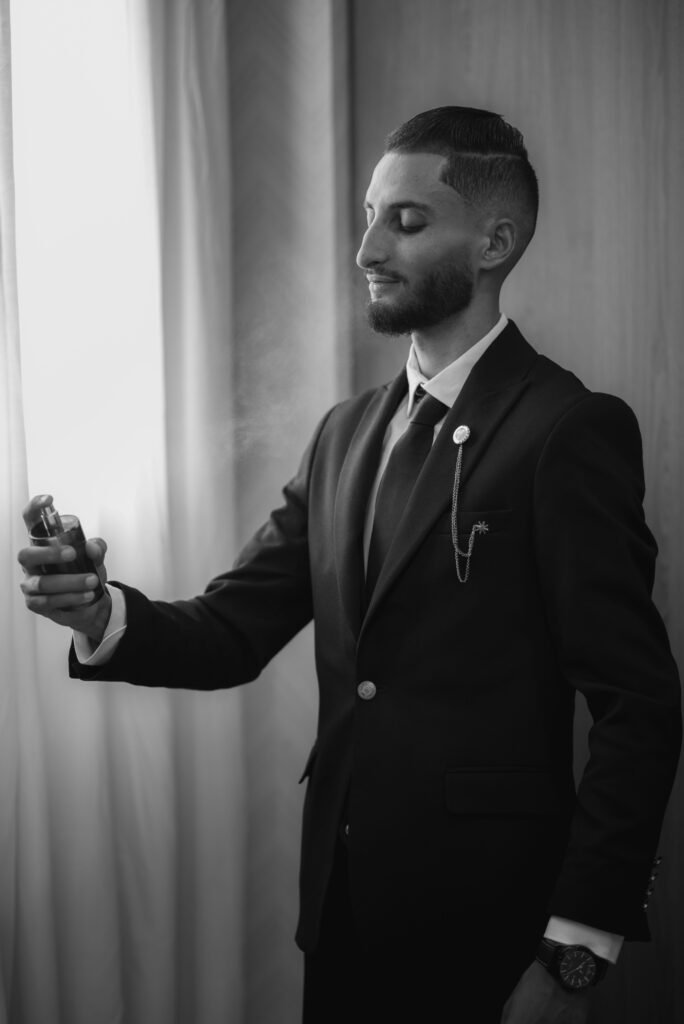 man applying cologne