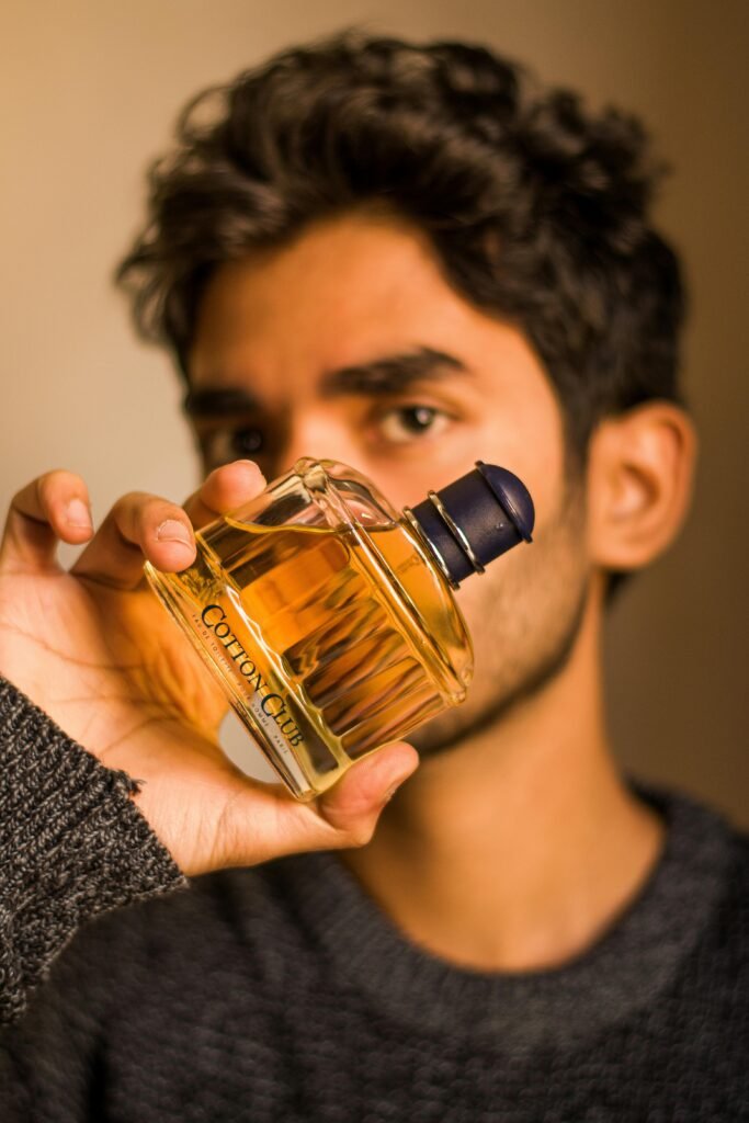 men holding perfume bottle
